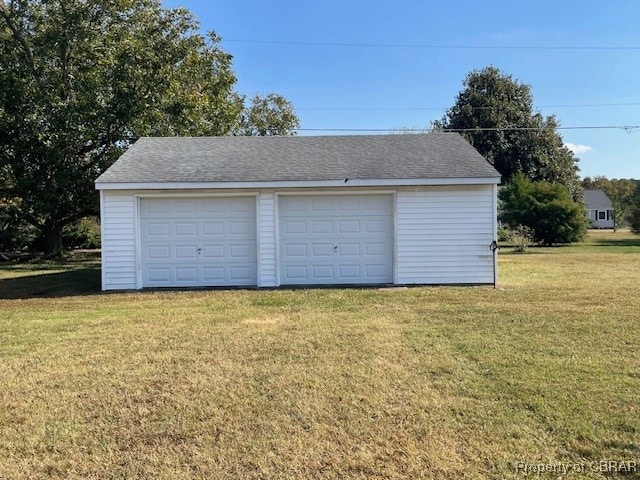 garage featuring a lawn