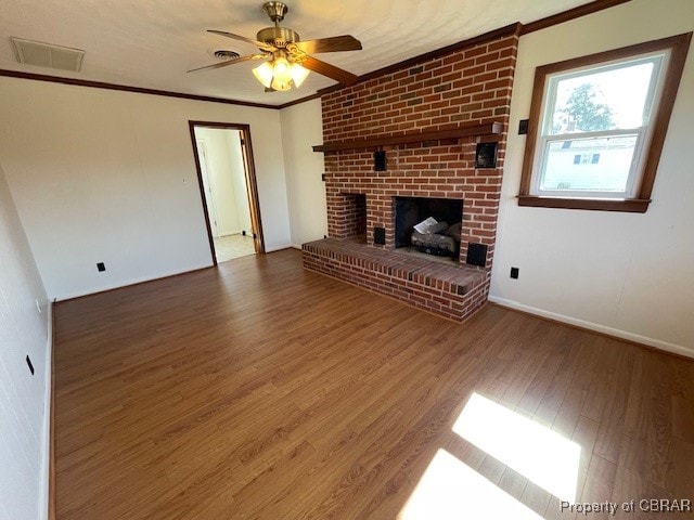 unfurnished living room featuring ornamental molding, ceiling fan, and dark hardwood / wood-style flooring