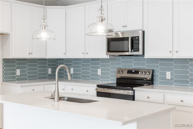 kitchen featuring white cabinetry, stainless steel appliances, and backsplash