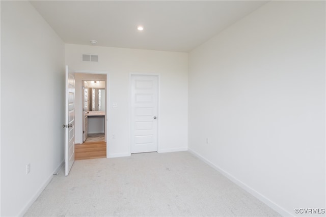 unfurnished bedroom with light carpet