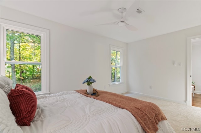 bedroom with light colored carpet and ceiling fan