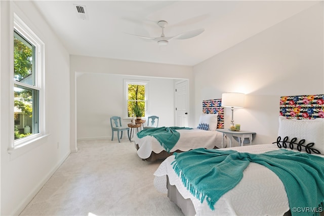 bedroom with light carpet and ceiling fan