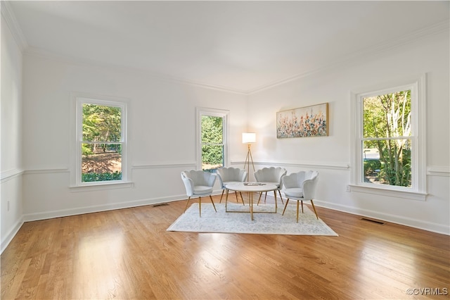 sitting room featuring crown molding, light hardwood / wood-style floors, and plenty of natural light