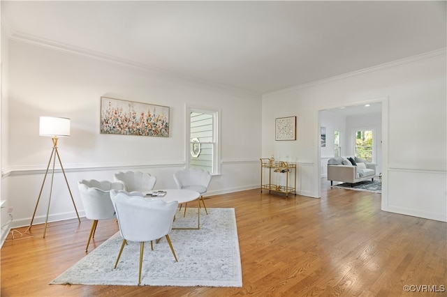 living room with ornamental molding and hardwood / wood-style flooring