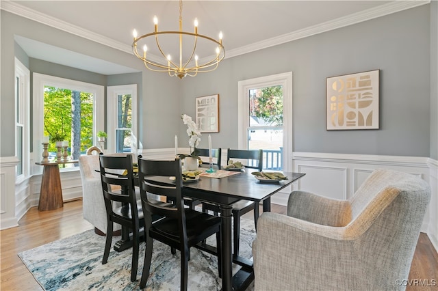 dining area featuring ornamental molding, light hardwood / wood-style flooring, and plenty of natural light