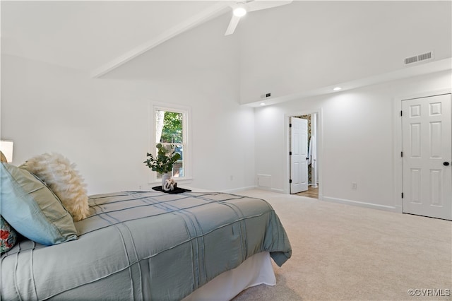 carpeted bedroom with beamed ceiling, high vaulted ceiling, and ceiling fan