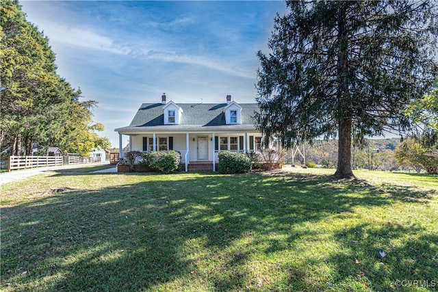 cape cod-style house with covered porch and a front yard