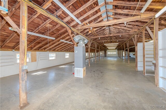 miscellaneous room featuring lofted ceiling and concrete flooring