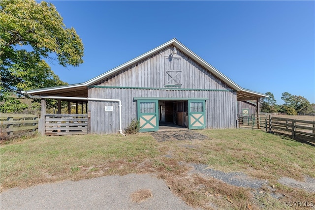 view of outbuilding featuring a yard