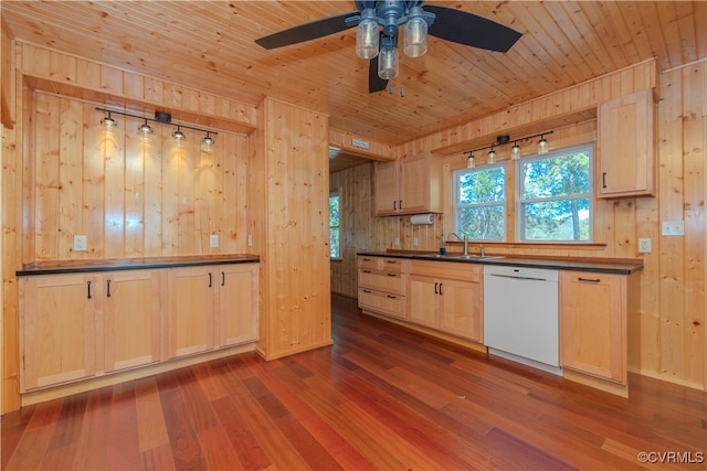 kitchen featuring wood walls, sink, white dishwasher, hardwood / wood-style flooring, and light brown cabinets