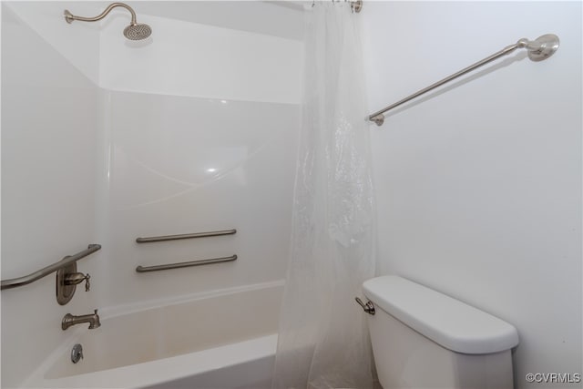 bathroom with shower / bath combo with shower curtain and toilet