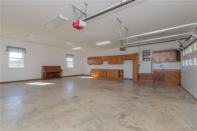 garage featuring a garage door opener and sink