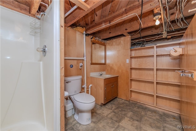 bathroom featuring vanity, a shower, and toilet