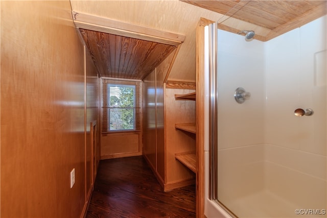 bathroom with walk in shower, wood walls, wooden ceiling, and wood-type flooring