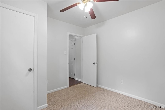 unfurnished bedroom featuring ceiling fan and carpet floors