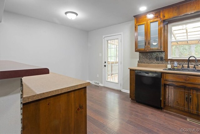 kitchen with black dishwasher, decorative backsplash, sink, and dark hardwood / wood-style floors