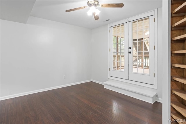 empty room featuring french doors, wood-type flooring, and ceiling fan