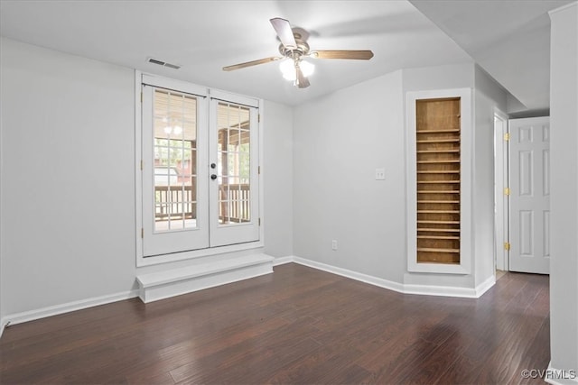 spare room featuring french doors, dark hardwood / wood-style floors, and ceiling fan