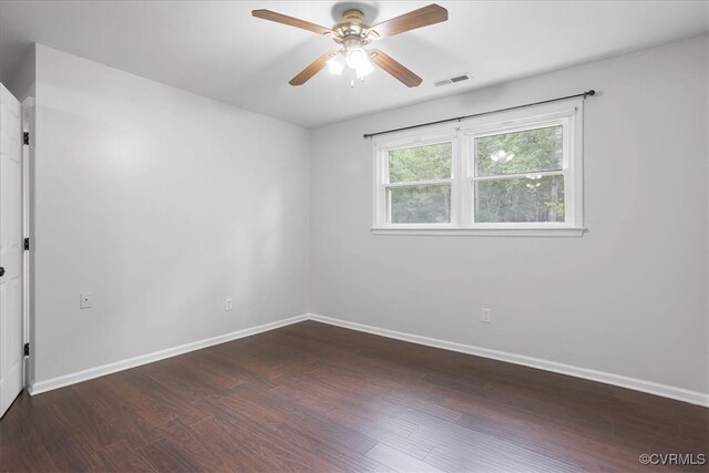 spare room with dark hardwood / wood-style floors and ceiling fan