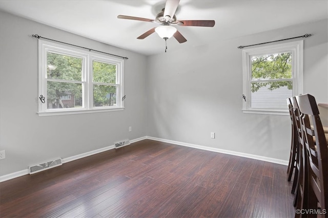 spare room with ceiling fan and dark hardwood / wood-style flooring