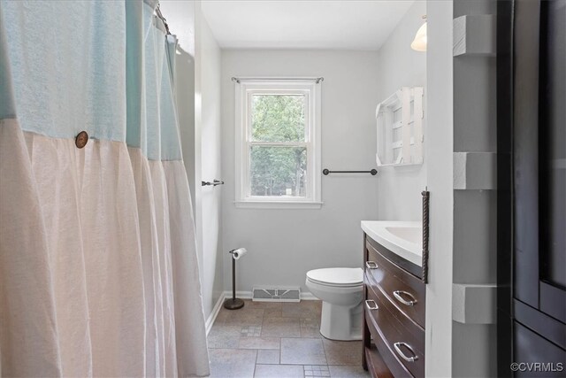 bathroom with vanity, toilet, and walk in shower