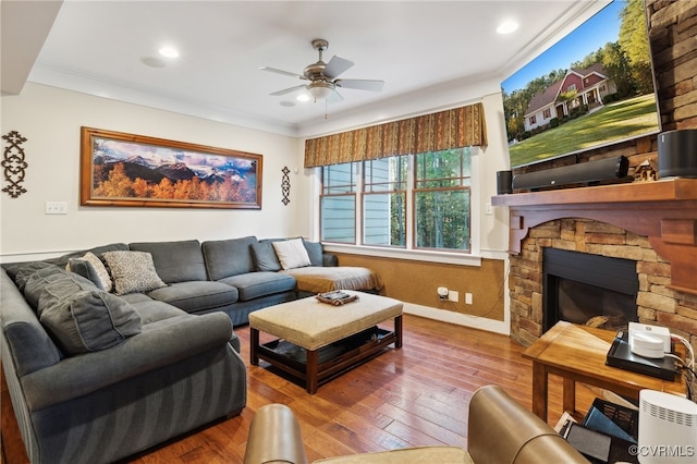 living room with ornamental molding, hardwood / wood-style floors, a fireplace, and ceiling fan