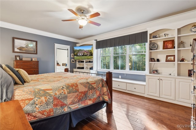 bedroom with dark wood-type flooring, ceiling fan, and ornamental molding