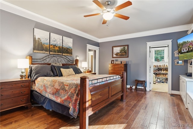 bedroom featuring ceiling fan, ornamental molding, and dark hardwood / wood-style flooring