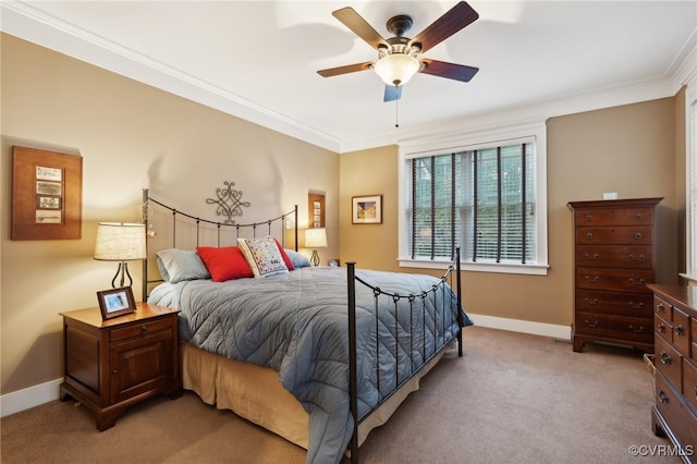 bedroom featuring ornamental molding, light colored carpet, and ceiling fan