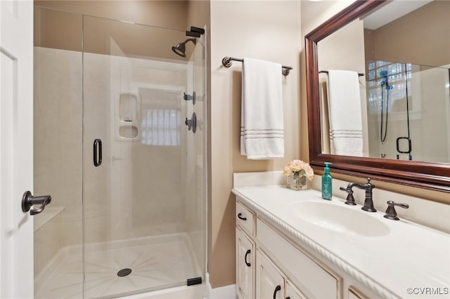 bathroom featuring vanity and a shower with shower door