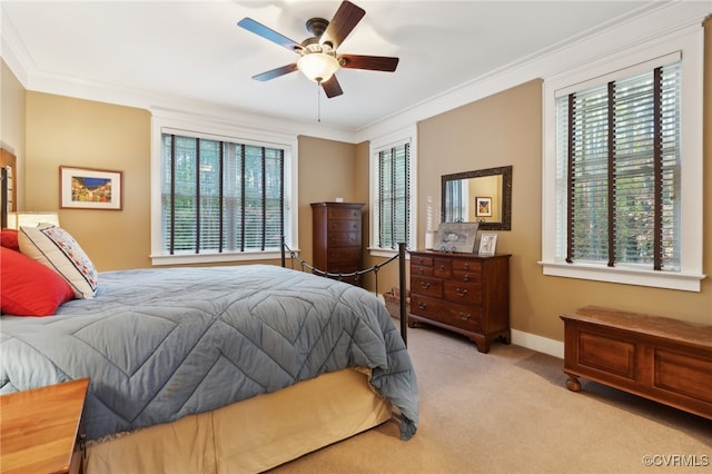 carpeted bedroom with crown molding, multiple windows, and ceiling fan