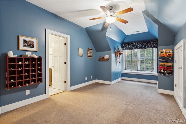 interior space with carpet flooring, vaulted ceiling, and ceiling fan