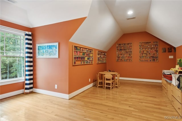 interior space with light hardwood / wood-style flooring and vaulted ceiling