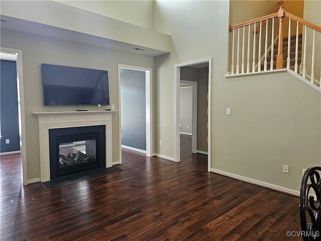 unfurnished living room with dark hardwood / wood-style floors