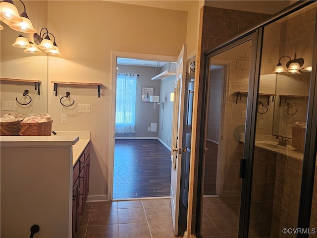 bathroom featuring hardwood / wood-style floors, vanity, and a shower with shower door