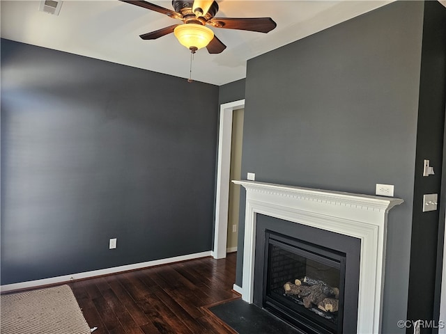 unfurnished living room with ceiling fan and dark hardwood / wood-style flooring