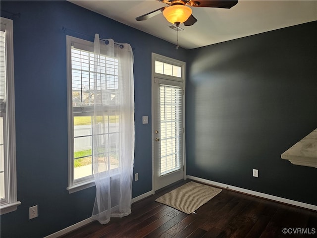 foyer with ceiling fan and dark wood-type flooring