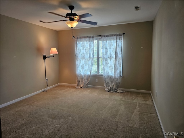 spare room with ceiling fan and light carpet