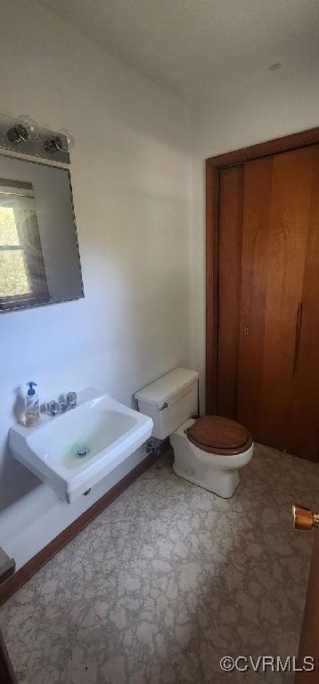 bathroom with toilet and sink