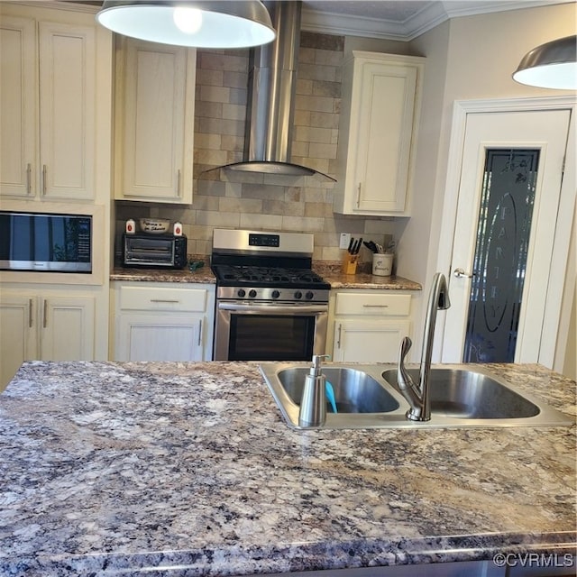 kitchen featuring decorative backsplash, wall chimney exhaust hood, dark stone countertops, sink, and appliances with stainless steel finishes