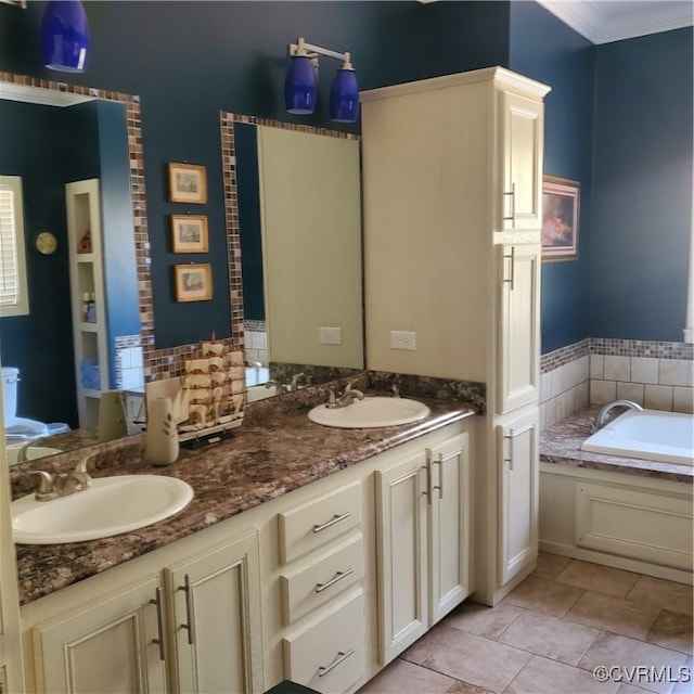 bathroom featuring vanity, ornamental molding, and a bathing tub