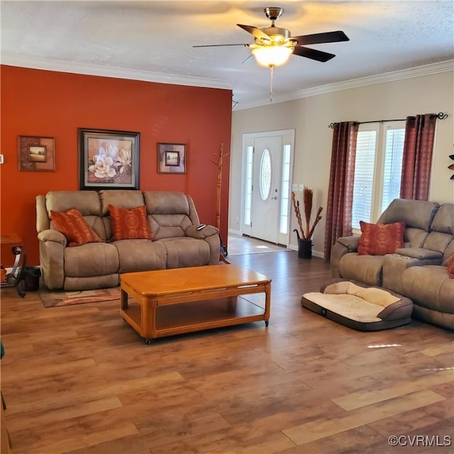 living room with ornamental molding, hardwood / wood-style floors, and ceiling fan