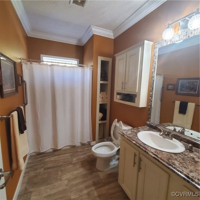 bathroom featuring a textured ceiling, toilet, a shower with curtain, vanity, and ornamental molding