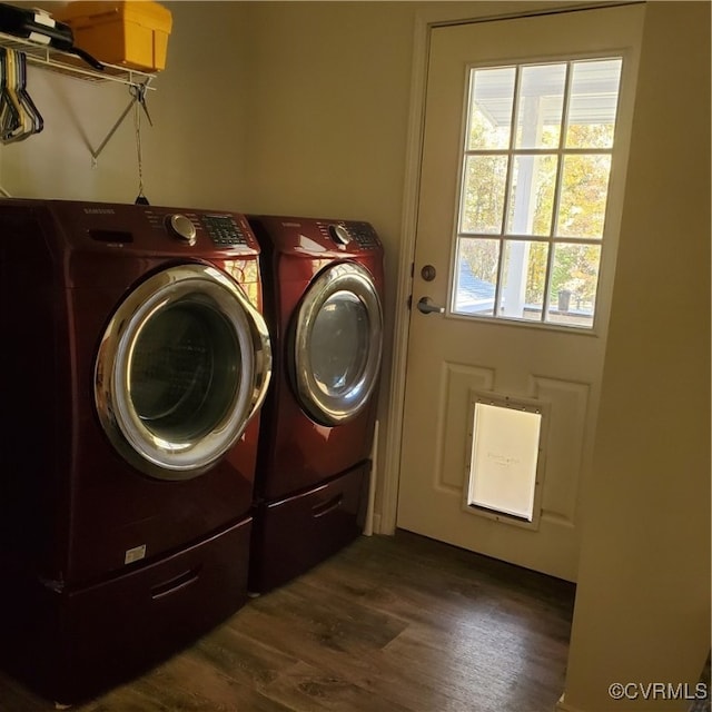 clothes washing area with washer and dryer and dark hardwood / wood-style flooring