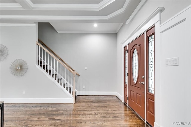 foyer entrance with ornamental molding and dark hardwood / wood-style flooring