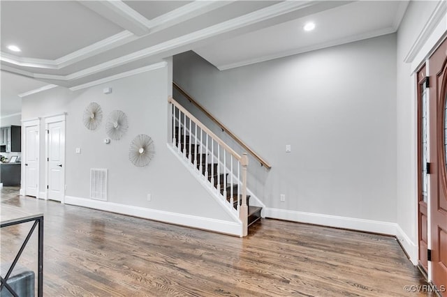 entrance foyer featuring crown molding and dark hardwood / wood-style flooring