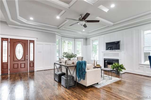 living room featuring a wealth of natural light, ceiling fan, and dark hardwood / wood-style flooring