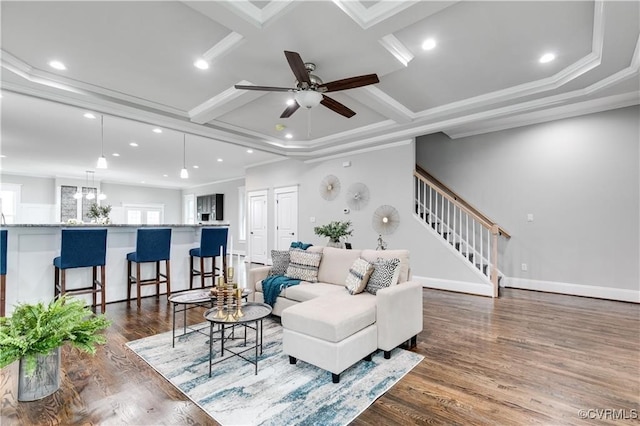 living room featuring crown molding, dark hardwood / wood-style floors, coffered ceiling, and ceiling fan