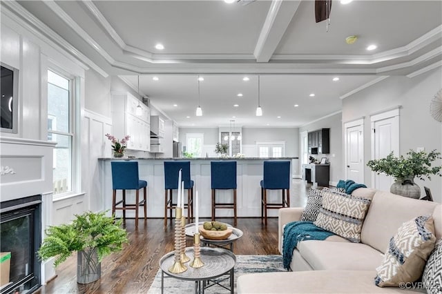 living room featuring crown molding, a wealth of natural light, and dark hardwood / wood-style floors