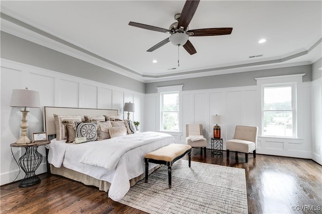 bedroom with ceiling fan, ornamental molding, and dark hardwood / wood-style floors